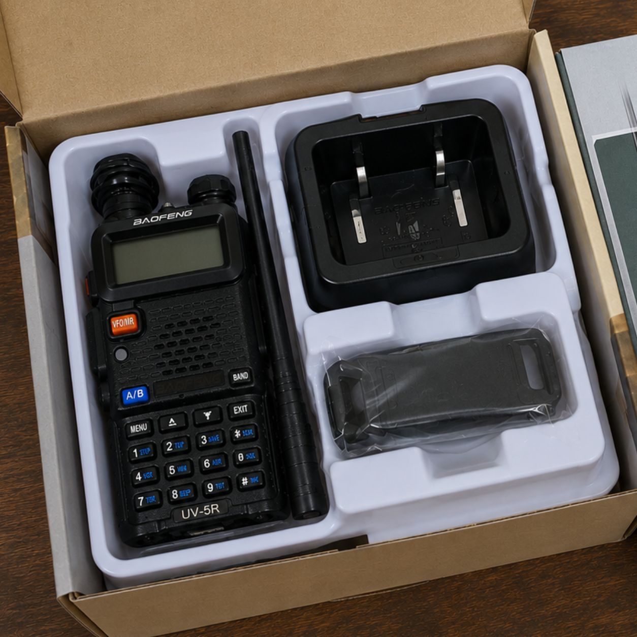 New operator's fresh Baofeng UV-5R beside the Starter Kit